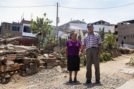 Lima - 19 March, 2018: Hilda Salon Cruz, 77 (left) and Narciso Vargas Huaman, 83 (right) outside their house in Villa Rocio del Triunfo in Lima after having their visual examination at the Taytawasi Senior Center in Villa Maria del Triunfo, Lima. They have been married for more than 50 years. Both of them are losing their vision and Narciso is also losing his hearing. This center for elderly people was open six years ago to provide health care and activities to the community of San Juan de Miraflores and Villa Maria del Triunfo neighborhoods in Lima. Every day dozens of elderly people came here to get together. Periodically, health workers from the near General Hospital Maria Auxiliadora and other Health Centers came here to get talks on eye health and to have vision examinations and send them to operate their eyes in case is necessary. Other services provided by the center includes general medicine, geriatrics, psychology, physical medicine and rehabilitation, dentistry, gynecology, nutrition, among others.