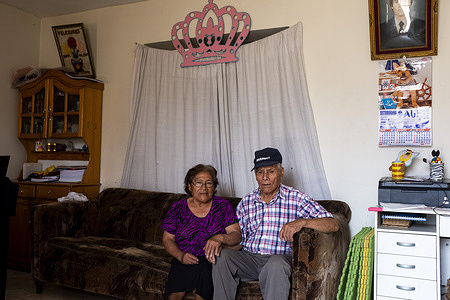 Lima - 19 March, 2018: Hilda Salon Cruz, 77 (left) and Narciso Vargas Huaman, 83 (right) in the living room of their house in Villa Rocio del Triunfo in Lima after having their visual examination at the Taytawasi Senior Center in Villa Maria del Triunfo, Lima. They have been married for more than 50 years. Both of them are losing their vision and Narciso is also losing his hearing. This center for elderly people was open six years ago to provide health care and activities to the community of San Juan de Miraflores and Villa Maria del Triunfo neighborhoods in Lima. Every day dozens of elderly people came here to get together. Periodically, health workers from the near General Hospital Maria Auxiliadora and other Health Centers came here to get talks on eye health and to have vision examinations and send them to operate their eyes in case is necessary. Other services provided by the center includes general medicine, geriatrics, psychology, physical medicine and rehabilitation, dentistry, gynecology, nutrition, among others.