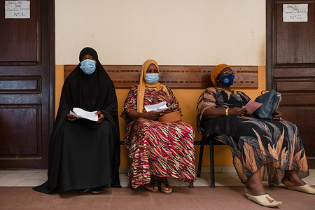Patients sit in a waiting area at Donka University Hospital in Conakry, Guinea, on 10 February 2021. The Francophone Regional Center for Training and Prevention of Gynaecological Cancers (Centre Régional Francophone de Formation et de Prévention des Cancers Gynécologiques) located at Donka University Hospital in Conakry, Guinea, is a regional training facility that offers screenings, training, and treatment of precancerous and cancerous lesions, including surgical treatment and chemotherapy when necessary. The Centre often hosts regional training workshops to provide technical support to African countries in order to improve their capacities for screening and preventive treatment of cervical cancer.