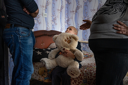 Psychiatrist Oleksii K., left, a member of the WHO-supported mobile mental health team, visits former patient Nataliia, 39, right, at her home on 15 February 2021 in Bylbasivka, Ukraine. Nataliia's son Kyryl, 8, sits in between listening to the conversation with a teddy bear. The COVID-19 pandemic and protracted conflict along the Ukraine-Russian border have had a devastating impact on Ukrainians with severe mental health conditions. These coinciding events have further limited their access to specialized care. Introduced by WHO in 2015, the community mental health teams project originally aimed to provide comprehensive community-based mental health care to people who faced consequences of the conflict. In 2020 WHO has reinforced its support to Ukraine in the area of mental health as a part of WHO Special Initiative for Mental Health, and seven community mental health teams are working across Ukraine during the COVID-19 pandemic. Community-based care is a new approach for mental health care in Ukraine but with the support from WHO, Ukraine aims to scale up the teams for people with severe mental health conditions throughout the country. A team based in Slovyansk and consisting of a psychiatrist, a psychologist, a nurse and a social worker travel to different settlements in the region to deliver specialized mental health care to their patients. The team helps the person to develop their recovery plan, cope with symptoms of mental health conditions and prevent crisis, supports them in maintaining activities of daily living and social relations, engages resources available in community for education, housing, employment and social protection.