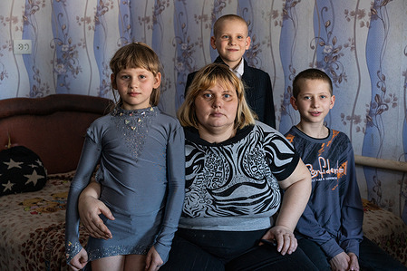Nataliia, 39, poses for a portrait with her children Nadiia, 9, Kyryl, 8; and Valerii, 12, from left, during a visit by the WHO-supported mobile mental health team on 15 February 2021 in Bylbasivka, Ukraine. Nataliia is a former patient of the mobile mental health team. The COVID-19 pandemic and protracted conflict along the Ukraine-Russian border have had a devastating impact on Ukrainians with severe mental health conditions. These coinciding events have further limited their access to specialized care. Introduced by WHO in 2015, the community mental health teams project originally aimed to provide comprehensive community-based mental health care to people who faced consequences of the conflict. In 2020 WHO has reinforced its support to Ukraine in the area of mental health as a part of WHO Special Initiative for Mental Health, and seven community mental health teams are working across Ukraine during the COVID-19 pandemic. Community-based care is a new approach for mental health care in Ukraine but with the support from WHO, Ukraine aims to scale up the teams for people with severe mental health conditions throughout the country. A team based in Slovyansk and consisting of a psychiatrist, a psychologist, a nurse and a social worker travel to different settlements in the region to deliver specialized mental health care to their patients. The team helps the person to develop their recovery plan, cope with symptoms of mental health conditions and prevent crisis, supports them in maintaining activities of daily living and social relations, engages resources available in community for education, housing, employment and social protection.
