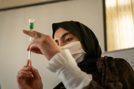 On 24 March 2021 Spray E. draws vaccine from a vial at a WHO-supported COVID-19 vaccinators' training session at the office of the Agency for Assistance and Development of Afghanistan (AADA) in Herat, Afghanistan. COVAX, the vaccines pillar of the Access to COVID-19 Tools (ACT) Accelerator, is co-led by the Coalition for Epidemic Preparedness Innovations (CEPI), Gavi, the Vaccine Alliance and WHO working in partnership with developed and developing country vaccine manufacturers, UNICEF, the World Bank, and others. It is the only global initiative that is working with governments and manufacturers to ensure COVID-19 vaccines are available worldwide to both higher-income and lower-income countries.