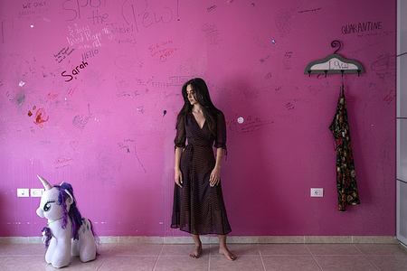 Katia, 20, in her childhood bedroom on 12 February 2021 in Ramallah, occupied Palestinian territory. Katia studies psychology in Paris but returned to her family home in March of 2020. She contracted COVID-19 shortly after and received care in the COVID-19 treatment and isolation centre at Hugo Chavez Hospital.