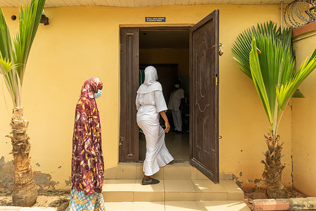 Nurse Hadiza leads a patient into the cervical cancer screening room at the RAiSE Foundation office in Niger State on 24 February 2021. Cervical cancer is the only cancer in the world that can be eliminated. It’s a cancer that is both preventable and curable through access to screenings, treatment, and vaccination. It is part of WHO’s global strategy to eliminate cervical cancer by (1) increasing HPV vaccination coverage (2) increasing screening coverage and (3) increasing access to treatment for precancerous lesions and for invasive cancer. By the year 2030, it is possible for all countries to achieve 90% HPV vaccination coverage, 70% screening coverage, and 90% access to treatment for cervical pre-cancer and cancer, including access to palliative care. Reaching these targets sets the world on the path toward elimination within the century. In Nigeria, the HPV vaccine is not yet available and treatment remains difficult to access for most women. The RAiSE foundation (Reproductive rights, advocacy, safe space and empowerment) was established by Dr Amina Abubakar Bello, an obstetrician and gynecologist (and First Lady of Niger State), to raise awareness on issues affecting the survival and growth of women and girls, including education and access to cervical cancer screenings and prevention. The organization advocates to improve reproductive health rights and campaigns to improve Maternal Health and Child Health in the region. Likewise, as part of the WHO’s global initiative to accelerate the elimination of Cervical Cancer, RAiSE offers financially accessible screenings at the foundation’s screening center where women found with any cancer or precancerous issue are given free treatment by the Foundation.