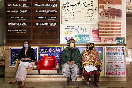 Shahid (left), Shagufta (centre) and Rabia (right) sit in the waiting area at Family Health Hospital in Lahore, Pakistan, on 1 February 2021.